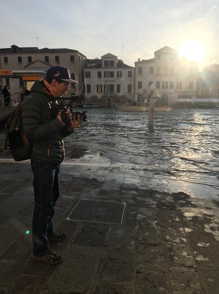 Filmmakers Riccardo Sartori documenting aqua alta in 2019 in Venice, Italy.